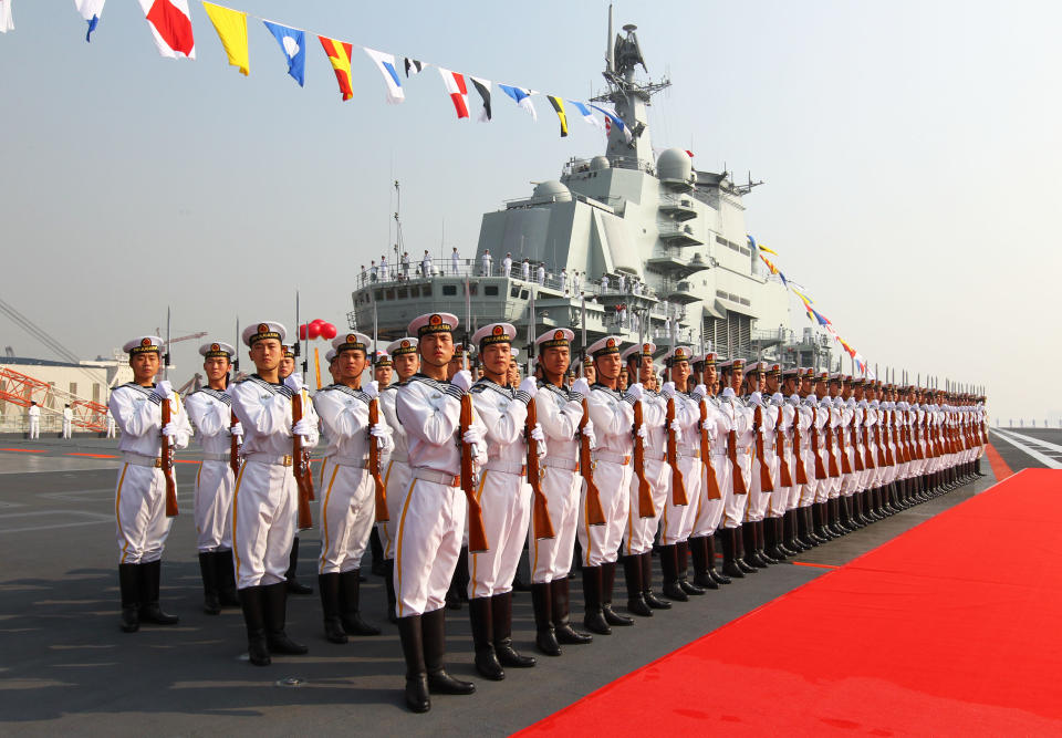 FILE - In this Sept. 25, 2012 file photo provided by China's Xinhua News Agency, sailors stand at attention on the deck of China's aircraft carrier "Liaoning" in Dalian, northeast China's Liaoning Province, as China formally entered its first aircraft carrier into service. As President Barack Obama tours Southeast Asia to push his year-old pivot to the Pacific policy, the big question on everybody's mind is how much of a role Washington, with its mighty military and immense diplomatic clout, can play in keeping the Pacific peaceful. (AP Photo/Xinhua, Zha Chunming, File) NO SALES