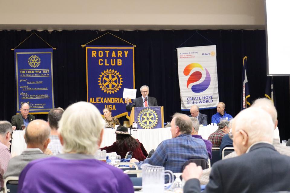 Attorney Ed Tarpley holds a piece of paper that contains Section 3 of the 14th Amendment to the U.S. Constitution Tuesday at the Rotary Club of Alexandria meeting. Tarpley spoke on his experiences as part of the legal team representing Stewart Rhodes at his trial on charges connected to the Jan. 6 insurrection.