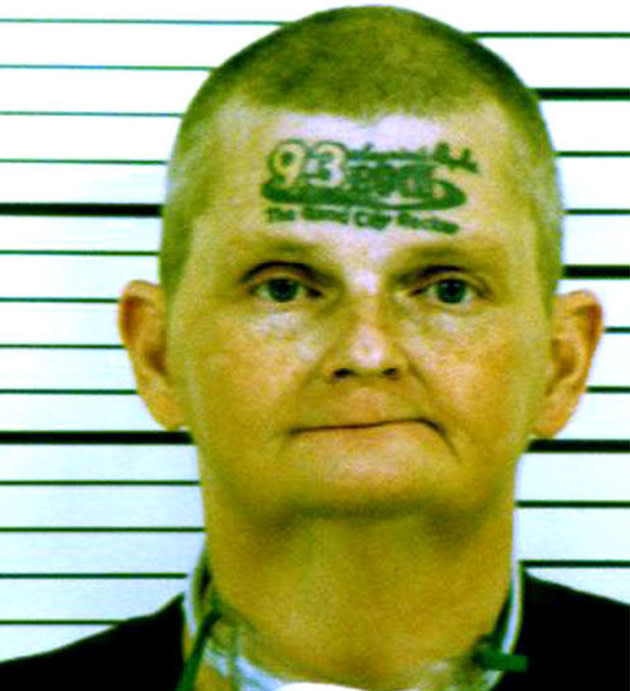 David Jonathan Winkelman, 48, has '93 Rock, the Quad city rocker' on his forehead. The Iowa man got the tattoo after a radio DJ offered a six figure sum to listeners if they tattooed the radio station's logo on their face (Rex Features)
