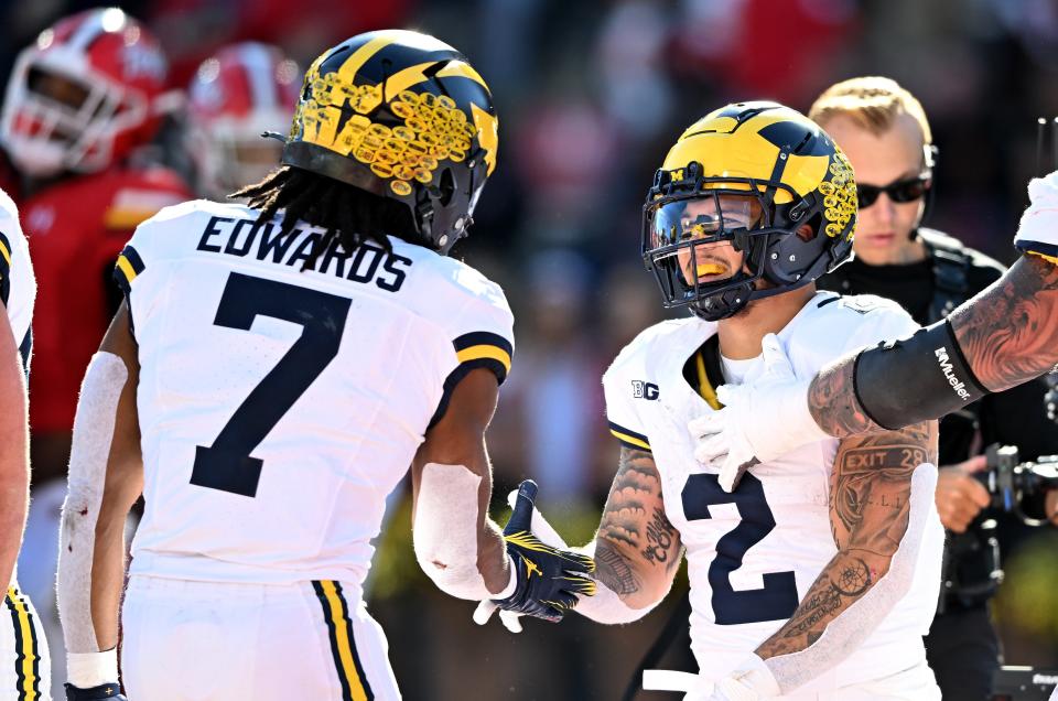 Blake Corum of the Michigan Wolverines celebrates with Donovan Edwards after scoring a touchdown in the second quarter against the Maryland Terrapins at SECU Stadium in College Park, Maryland, Nov. 18, 2023.