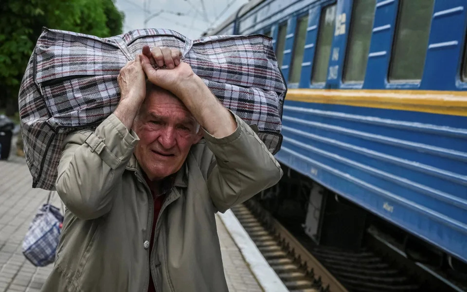 A man boards a train to Lviv during an evacuation effort from war-affected areas of eastern Ukraine - VIACHESLAV RATYNSKYI/REUTERS