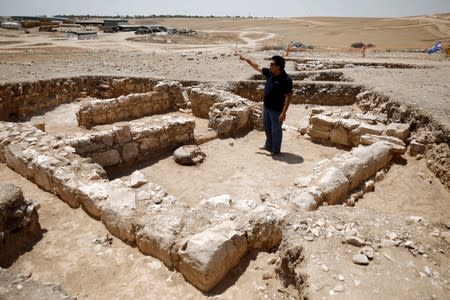An archaeologist gestures as he stands inside the remains of a mosque discovered by the Israel Antiquities Authority and which they say is one of the world's oldest mosques, in the outskirts of the Bedouin town of Rahat in southern Israel