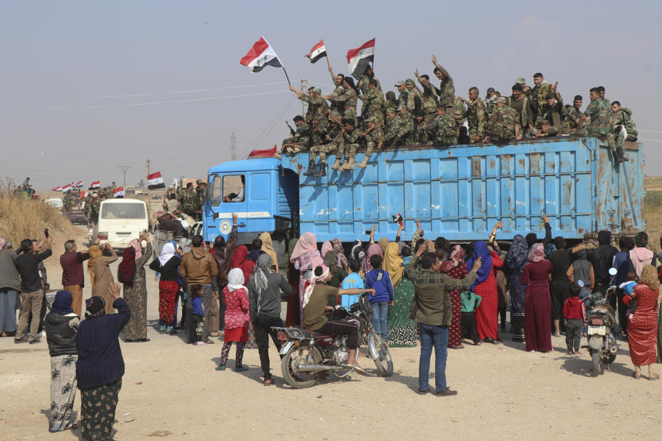 File - In this Saturday, Oct. 26, 2019 file photo, Syrian government forces reinforcements arrive near the city of Ras al-Ayn, in the north of Syria.Syrians are marking 10 years since peaceful protests against President Bashar Assad's government erupted in March 2011, touching off a popular uprising that quickly turned into a full-blown civil war. (AP Photo)