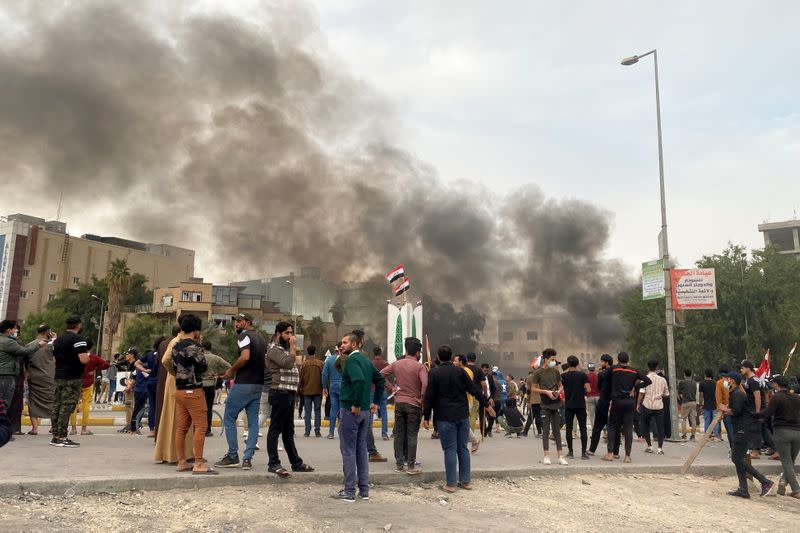 Smoke rises during clashes between anti-government protesters and supporters of Iraqi Shi'ite cleric Moqtada al-Sadr in Nassiriya