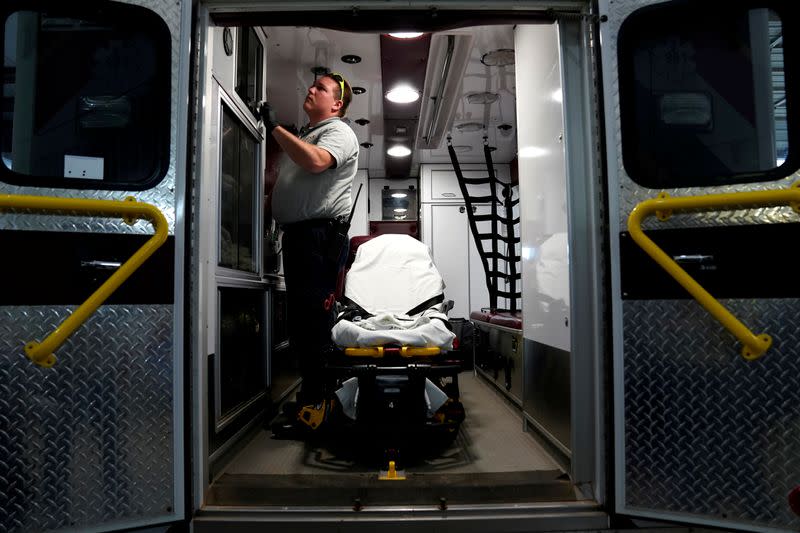 REACT EMS paramedic Andrew Sherman disinfects an ambulance in Shawnee