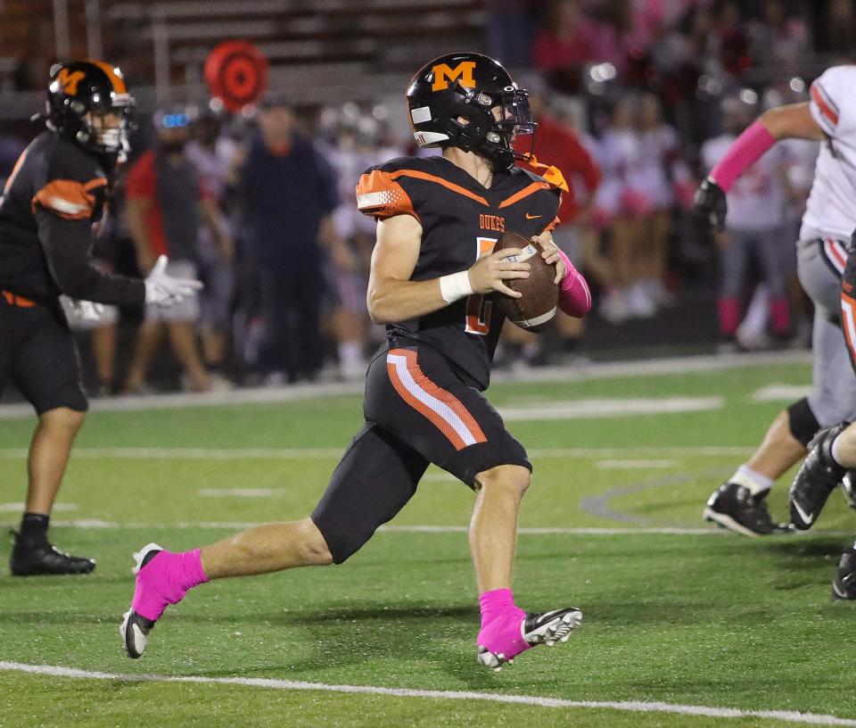 Marlington's Beau Himmelheber looks down field for a receiver against Minerva, Friday, Oct. 6, 2023.