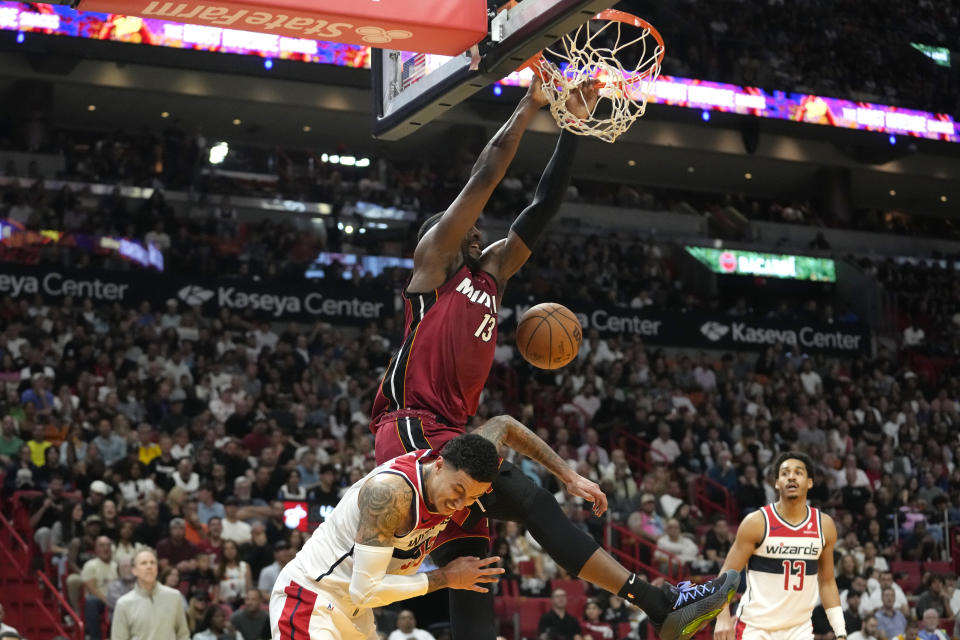 Miami Heat center Bam Adebayo (13) dunks over Washington Wizards forward Kyle Kuzma, bott0m center, during the second half of an NBA basketball game, Sunday, March 10, 2024, in Miami. (AP Photo/Lynne Sladky)