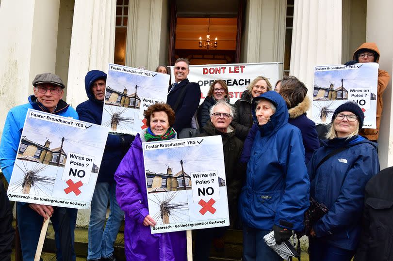 Residents protest outside Southport Town Hall over Openreach poles installations in the town.