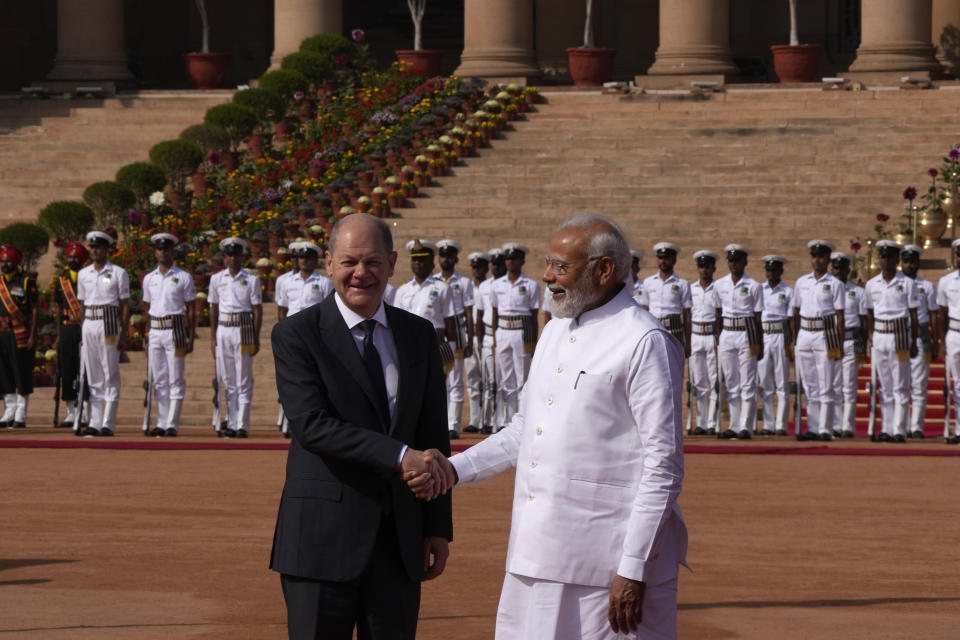 Indian Prime Minister Narendra Modi, right, welcomes German Chancellor Olaf Scholz, during latter's ceremonial reception at the Indian presidential palace in New Delhi, India, Saturday, Feb. 25, 2023. (AP Photo/Manish Swarup)