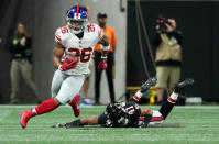 Oct 22, 2018; Atlanta, GA, USA; New York Giants running back Saquon Barkley (26) runs after a catch against Atlanta Falcons defensive back Sharrod Neasman (41) in the first quarter at Mercedes-Benz Stadium. Mandatory Credit: Jason Getz-USA TODAY Sports