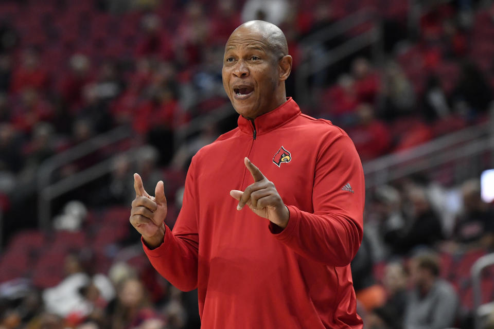 Louisville head coach Kenny Payne sends instructions in to his team during the first half of an NCAA college basketball game against Miami in Louisville, Ky., Sunday, Dec. 4, 2022. (AP Photo/Timothy D. Easley)