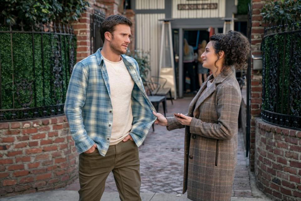 Jenny Slate holding onto Scott Eastwood's shirt