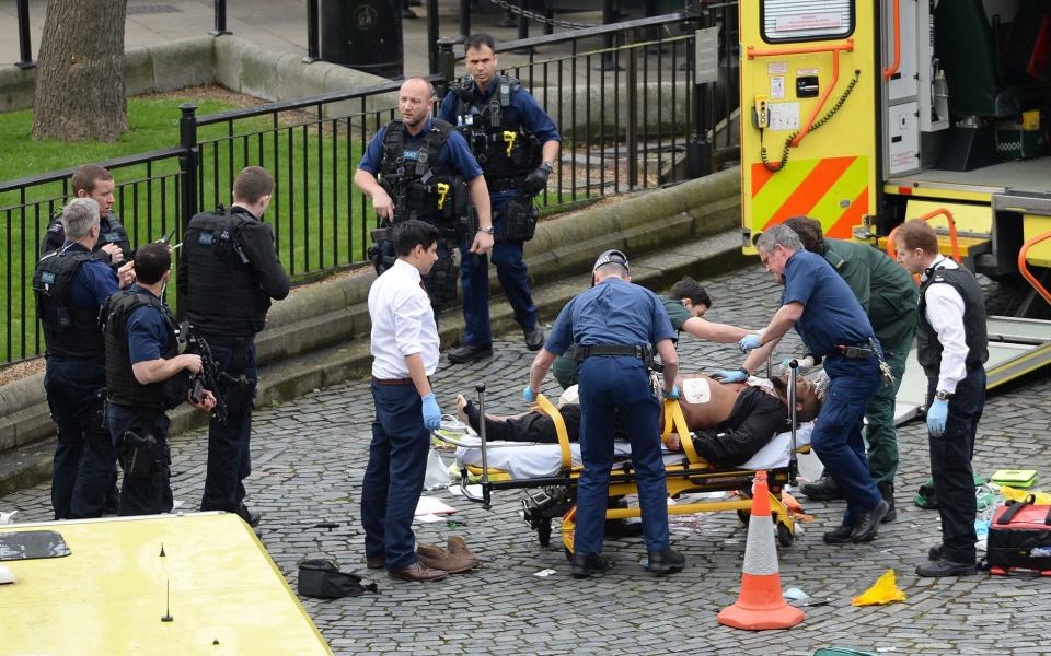 Emergency services at the scene outside the Palace of Westminster, London, after policeman has been stabbed - Credit: Stefan Rousseau/PA