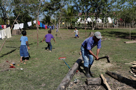 FILE PHOTO: A man chops wood in the village where Jakelin, a 7-year-old girl who died in U.S. custody, used to live in San Antonio Secortez, municipality of Raxruha, Guatemala December 19, 2018. REUTERS/Luis Echeverria/File Photo