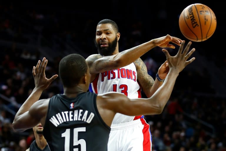 Marcus Morris of the Detroit Pistons passes to a teammate around Isaiah Whitehead of the Brooklyn Nets during the first half, at the Palace of Auburn Hills in Michigan, on March 30, 2017