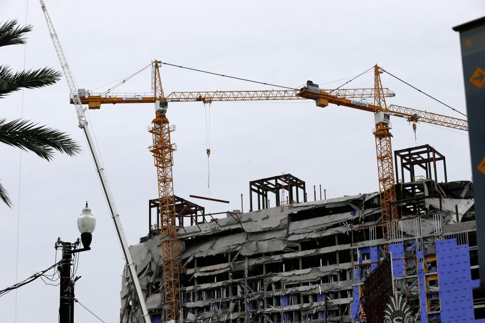 Two unstable cranes loom over the New Orleans Hard Rock Hotel, which collapsed last Saturday, killing three workers. Authorities say explosives will be strategically placed on the cranes in hopes of bringing them down with a series of small, controlled blasts ahead of approaching tropical weather.