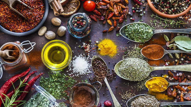 Herbs, spices, and olive oil on table