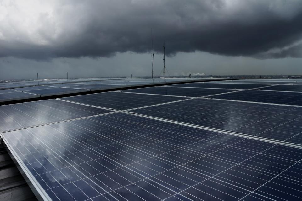 Storm clouds over a solar panel installation