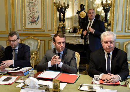 French President Emmanuel Macron (C) sits with Secretary General of the Elysee Palace Alexis Kohler (L) and Admiral Bernard Rogel as they attend a weekly Defense Council at the Elysee Palace in Paris, France, May 24, 2017. REUTERS/Stephane De Sakutin/Pool