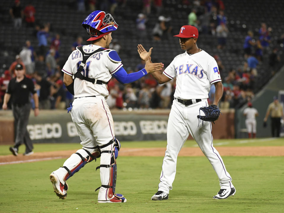 Texas Rangers catcher Robinson Chirinos and relief pitcher Jose Leclerc celebrate after Leclerc struck out Los Angeles Angels' Eric Young Jr. for the final out of a baseball game Thursday, Aug. 16, 2018, in Arlington, Texas. Texas won 8-6. (AP Photo/Jeffrey McWhorter)