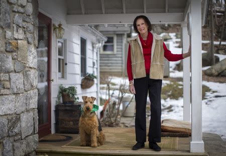 Renee Richards poses for a portrait as she stands on the front porch of her home in Carmel, New York, with her dog Rocco, March 25, 2015. REUTERS/Mike Segar