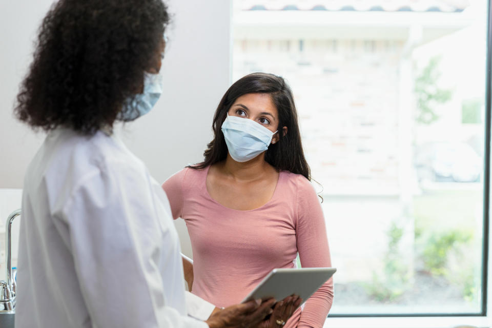 A woman and doctor talking at an appointment