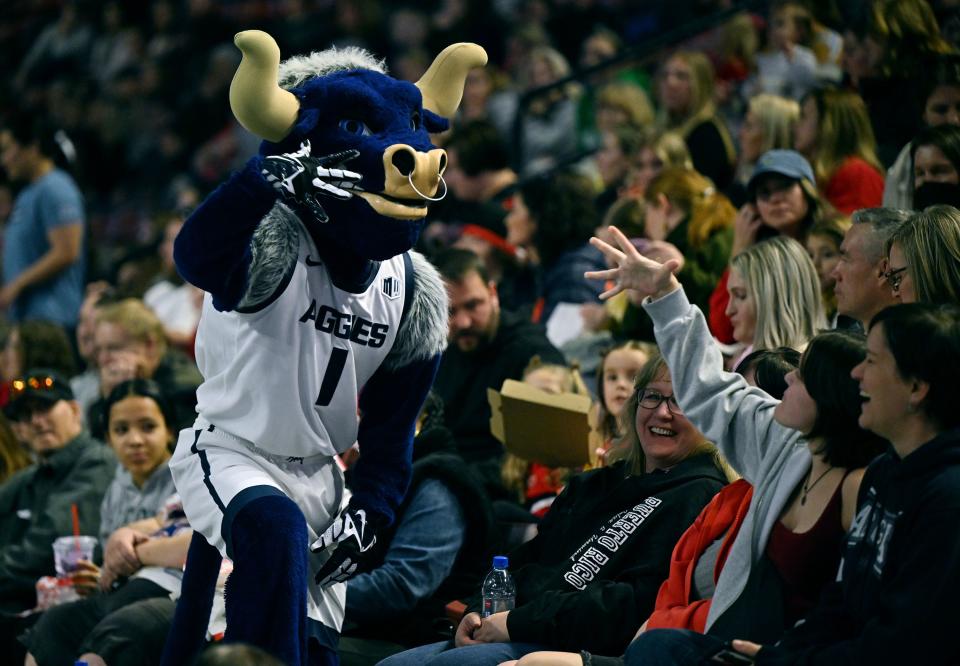 Utah State’s mascot Big Blue, plays with fans as BYU, Utah, SUU and Utah State meet in the Rio Tinto Best of Utah Gymnastics competition at the Maverick Center in West Valley City on Monday, Jan. 15, 2024. | Scott G Winterton, Deseret News