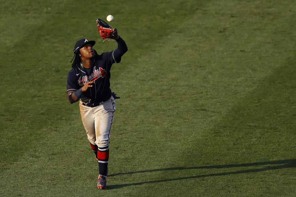 Atlanta Braves center fielder Ronald Acuna Jr. catches a fly out by Philadelphia Phillies' Bryce Harper during the fifth inning of the second baseball game in a doubleheader, Sunday, Aug. 9, 2020, in Philadelphia. (AP Photo/Matt Slocum)