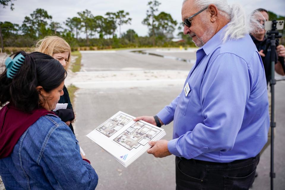 Arol Buntzman, chairman of the Immokalee Fair Housing Alliance, shows mock-ups to Bernabela Gonzalez of the three bedroom home being built for them at the corner of North 19th Street and Lake Trafford Road in Immokalee on Friday, Jan. 27, 2023.