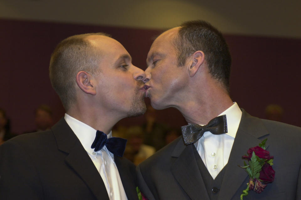 Gert Kasteel, left, and Dolf Pasker kiss after exchanging vows at Amsterdam's City Hall early Sunday, April 1, 2001. The pair was among four couples to get married under a new law which took effect April 1, 2001, the world's first such law allowing same-sex marriages with equal rights. Same-sex marriage is now legal in 28 countries, including most of Western Europe, as well as in the self-governing island of Taiwan. (AP Photo/Peter Dejong)