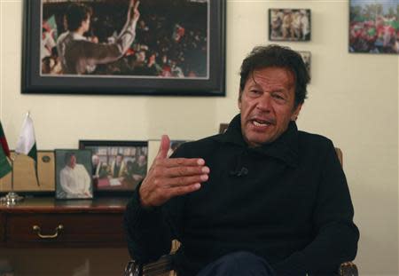 Imran Khan, Pakistani cricketer-turned-politician and chairman of the Pakistan Tehreek-e-Insaf (PTI) political party, speaks during an interview with Reuters at his office in Islamabad November 8, 2013. REUTERS/Mian Khursheed