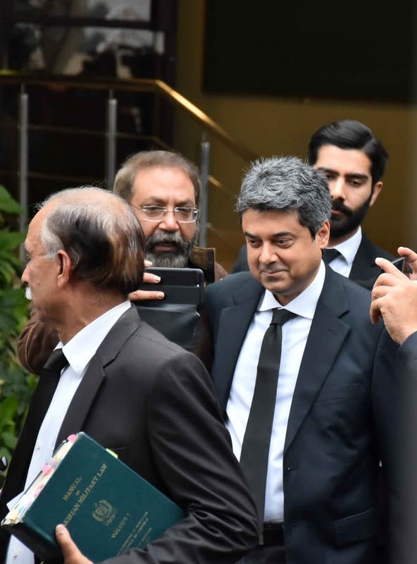 Mohammad Farogh Naseem, defence lawyer of the Pakistan's Chief of Army Staff (COAS) General Qamar Javed Bajwa, walks with lawyers as he leaves the Supreme Court premises in Islamabad