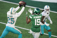Miami Dolphins' Xavien Howard (25), left, breaks up a pass intended for New York Jets' Breshad Perriman (19) during the first half of an NFL football game, Sunday, Nov. 29, 2020, in East Rutherford, N.J. (AP Photo/Corey Sipkin)