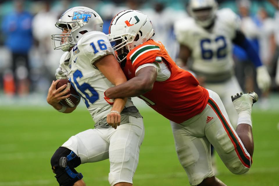 Miami linebacker Corey Flagg Jr. sacks Middle Tennessee quarterback Chase Cunningham during the second half of Saturday's game at Hard Rock Stadium.