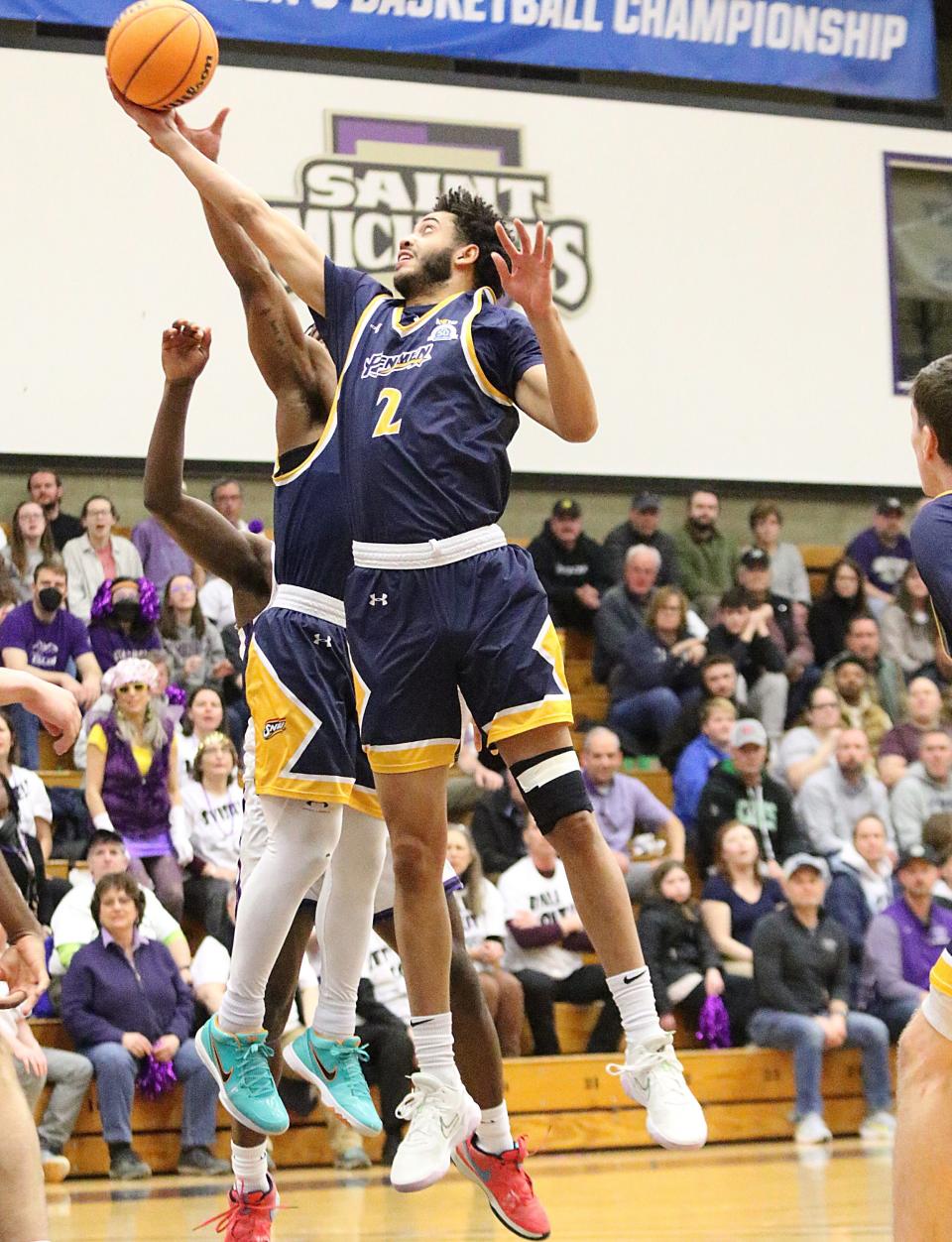Southern New Hampshire's Preston Santos pulls down a rebound during the Penmen's 73-61 win over St. Michael's College in the NCAA D-II East Regional Championship game at Ross Sports Center on Tuesday, March 19, 2024.