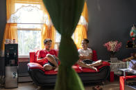 Bawi UK, 22, right, chats with his brother, Leng Nung, 20, in the apartment they share in Providence, R.I., Saturday, Sept. 26, 2020. UK was a small child when his parents fled Myanmar, leaving him and his siblings to be cared for by their maternal grandmother. UK said the family suffered discrimination as Christians in a predominantly Buddhist nation. The military government was also trying to forcibly conscript his father. "To run for office, you had to be a Buddhist; to rent a house, you had to be Buddhist," said UK, a social work student at Rhode Island College and a youth leader at the Refugee Dream Center, an advocacy organization in Providence. (AP Photo/David Goldman)