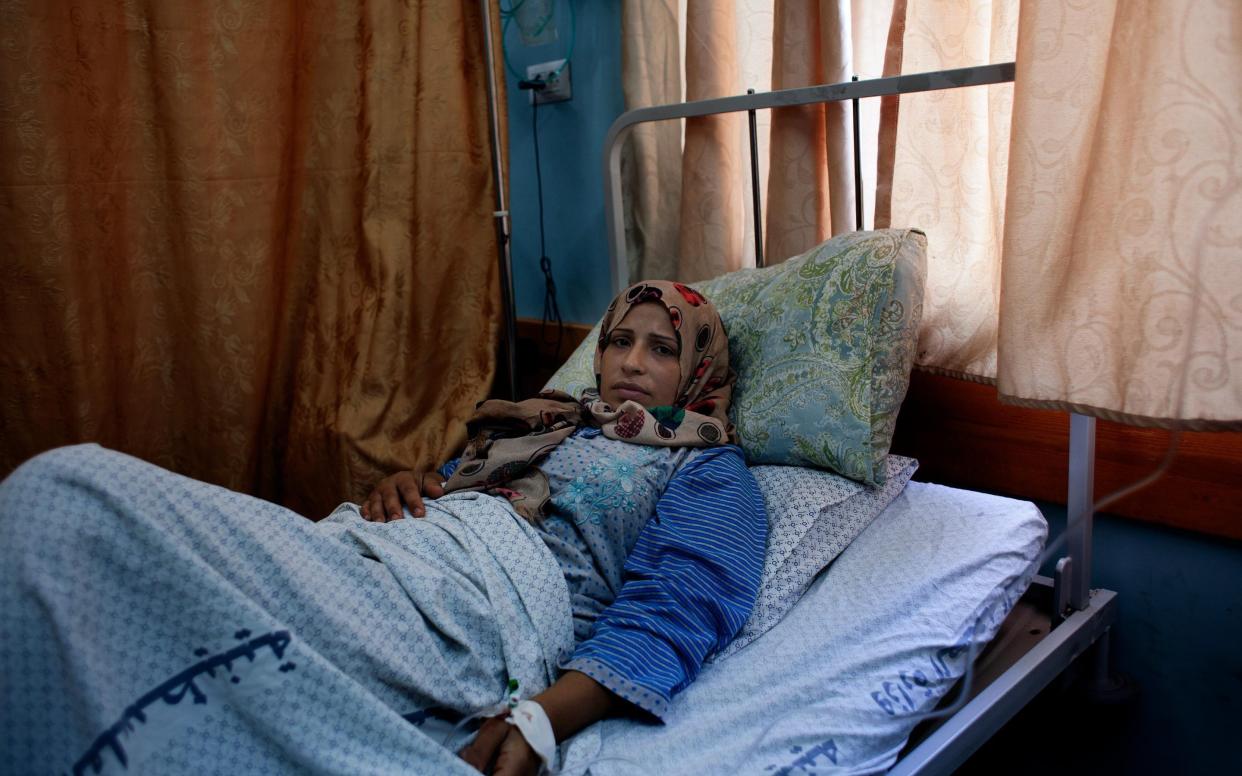 Soha Mosleh lies on a cot as she recovers in the maternity ward of Al-Shifa Hospital in Gaza. On 25 July 2014 she gave birth to a stillborn baby girl. According to her doctors, the stillbirth was caused by stress the conflict induced. - Loulou d'Aki / Unicef