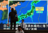 <p>People pass a public TV screen broadcasting news of North Korea’s ballistic missile which landed in the waters of Japan’s economic zone (EEZ) in Tokyo Tuesday, July 4, 2017. (Photo: Eugene Hoshiko/AP) </p>
