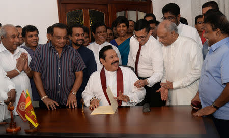 Sri Lanka's former leader Mahinda Rajapaksa shares a moment with his political party supporters after he resigned from the prime minister post in Colombo, Sri Lanka December 15, 2018. REUTERS/Stringer