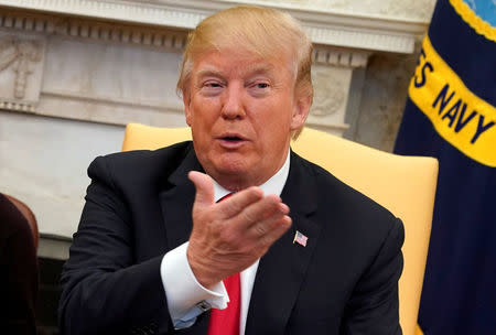 U.S. President Donald Trump talks to the media during his meeting with North Korean defectors in the Oval Office of the White House in Washington, U.S., February 2, 2018. REUTERS/Yuri Gripas