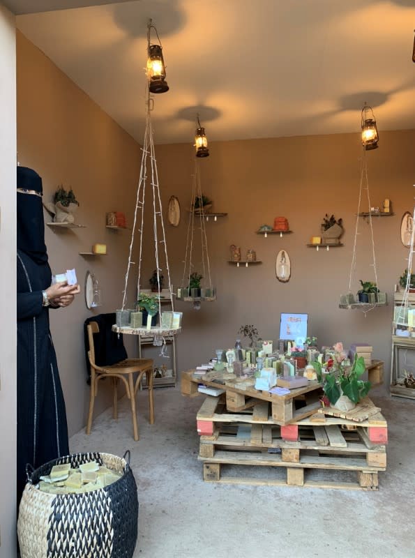 Abeer al-Howayan stands at her small shop, in the historical area of Tantoura in Al-Ula