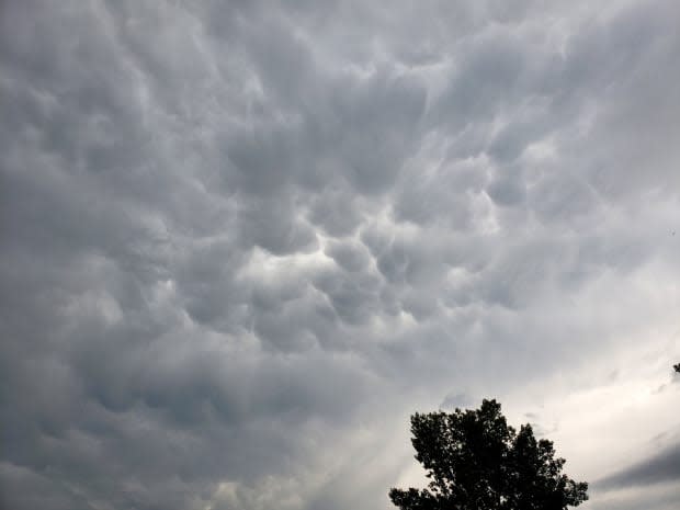 Storm clouds threaten Oyen, Alta., around 5:30 p.m. on Tuesday. A tornado warning was issued for the region at 5:15 p.m. The alert ended shortly after 6 p.m. (Tracy Hudson/Twitter - image credit)