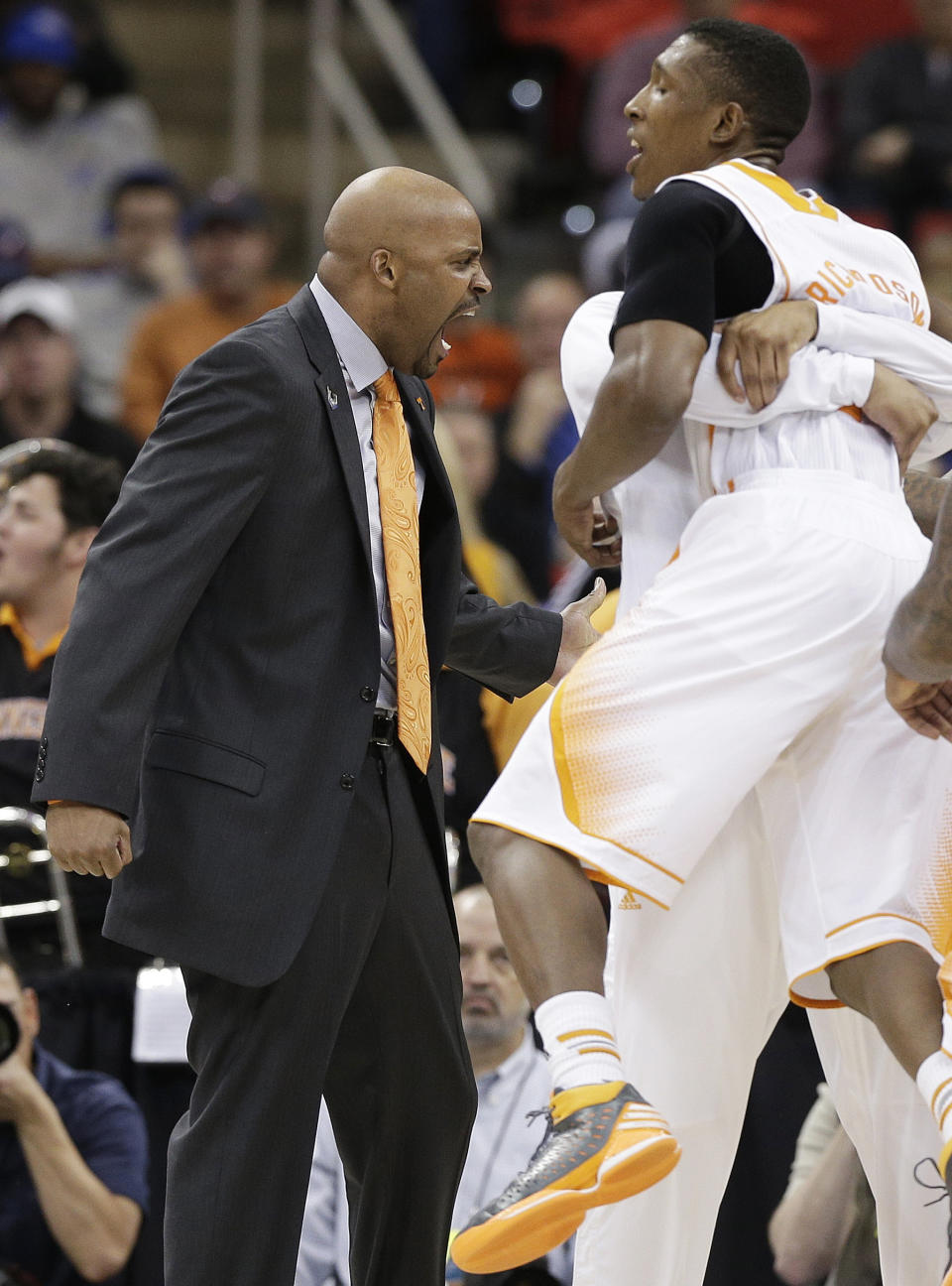 Tennessee head coach Cuonzo Martin celebrates near the end of the first half of an NCAA college basketball third-round tournament game against Mercer, Sunday, March 23, 2014, in Raleigh. (AP Photo/Chuck Burton)