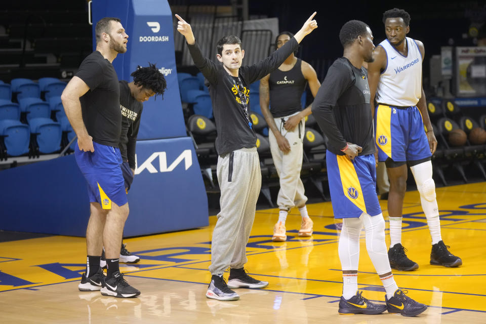 Santa Cruz Warriors coach Nicholas Kerr, middle, gestures during the team's basketball practice in Santa Cruz, Calif., Friday, Jan. 12, 2024. Each day, Kerr strives to find a balance between fun and fire while leading Golden State's developmental G League team minus all the big stars - like Stephen Curry - his famous father, Steve Kerr, gets to work with every day. (AP Photo/Jeff Chiu)