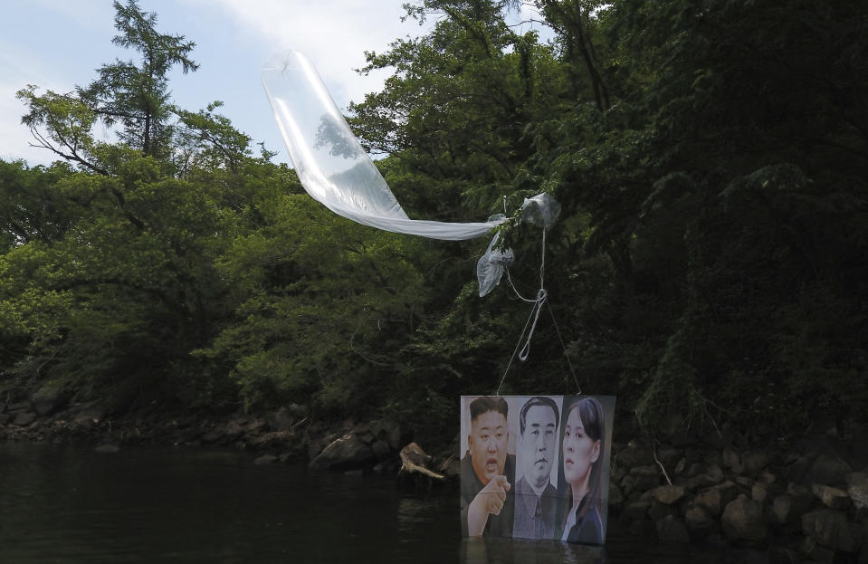 A balloon carrying a banner with images of North Korean leader Kim Jong Un, left, the late leader Kim Il Sung, center, and Kim Yo Jong, the powerful sister of Kim Jong Un, released by Fighters For Free North Korea, is seen in Hongcheon, South Korea, Tuesday, June 23, 2020. A South Korean activist said Tuesday hundreds of thousands of leaflets had been launched by balloon across the border with North Korea overnight, after the North repeatedly warned it would retaliate against such actions. (Yang Ji-woong/Yonhap via AP)