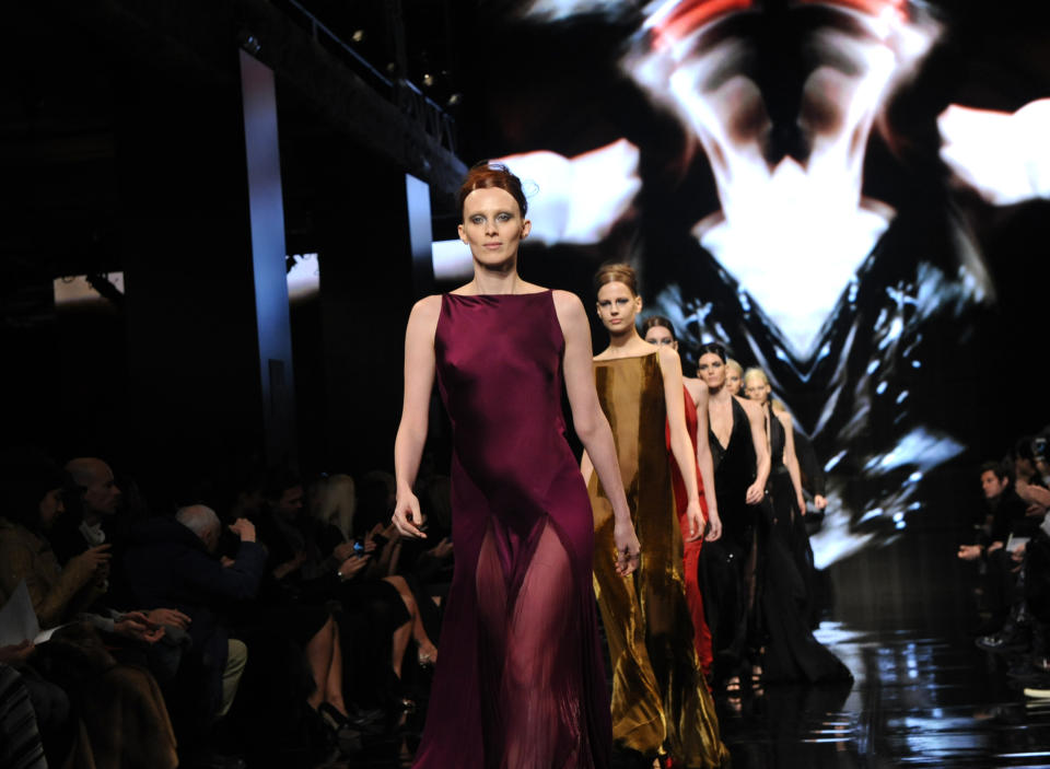 Model Karen Elson leads the finale for the Donna Karan New York Fall 2014 collection during Fashion Week, Monday, Feb. 10, 2014, at 23 Wall Street in New York. (AP Photo/Diane Bondareff)