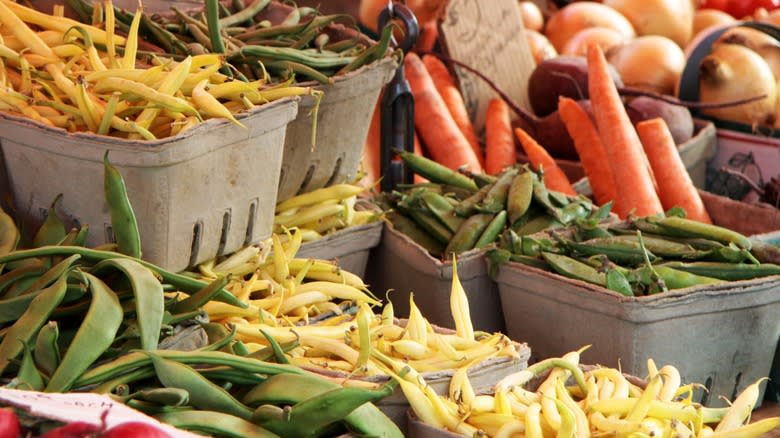 Various fresh beans and peas for sale at a farmers market