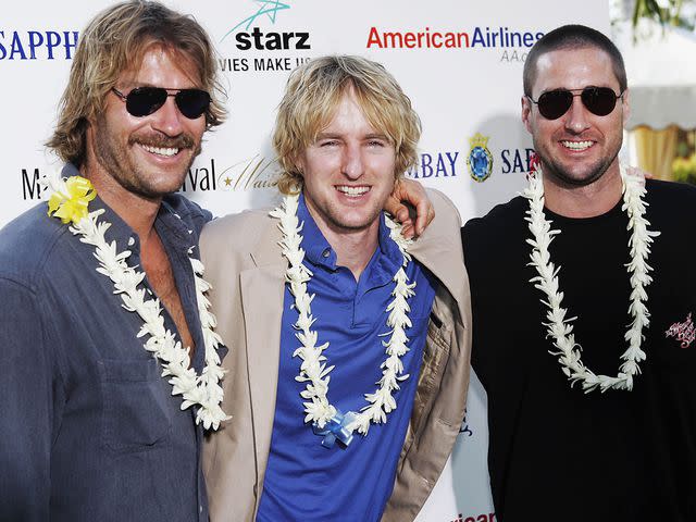 <p>Marco Garcia/Getty</p> Andrew, Luke and Owen Wilson during the Maui Film Festival in 2005.