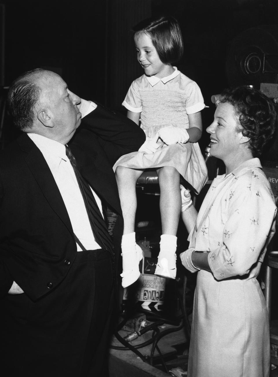 British director and producer Alfred Hitchcock appears with his eldest granddaughter, six-year old Mary O'Connell, who makes her acting debut on Sept. 24, 1959, when she appears with her mother, actress Pat Hitchcock, right, in an episode of the famed "Alfred Hitchcock presents" television series in America. The only child of Alfred Hitchcock has died. Pat Hitchcock, who made a memorable appearance in her father's "Strangers on a Train," was 93. (AP Photo)