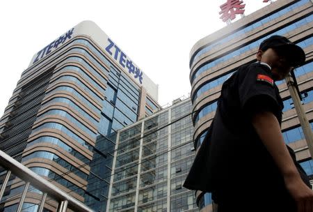 FILE PHOTO: A security guard walks past a building of ZTE Beijing research and development center in Beijing, China June 13, 2018. REUTERS/Jason Lee/File Photo